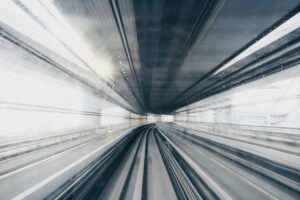 a blurry train tracks in a tunnel